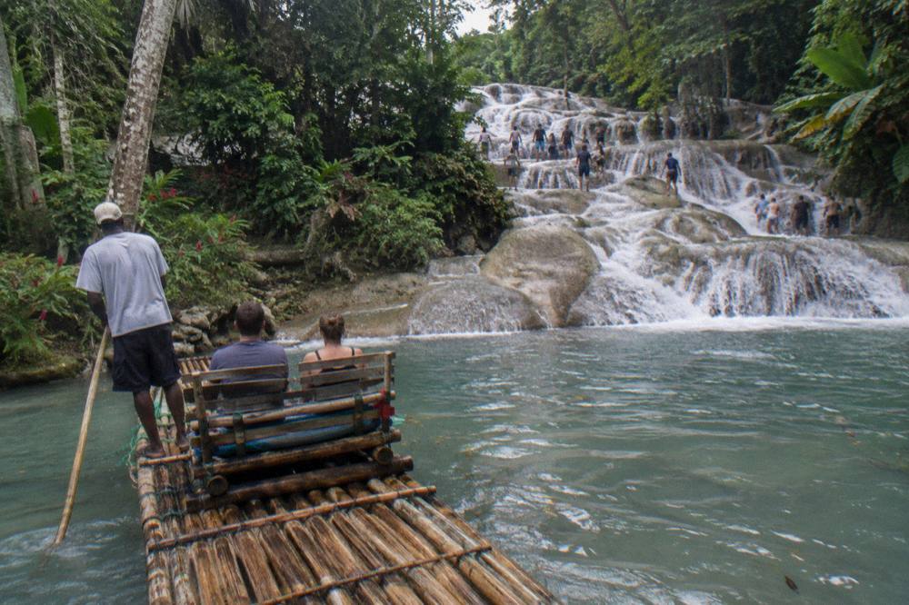 Waterfall terraces surrounded by tropical trees under an overcast sky