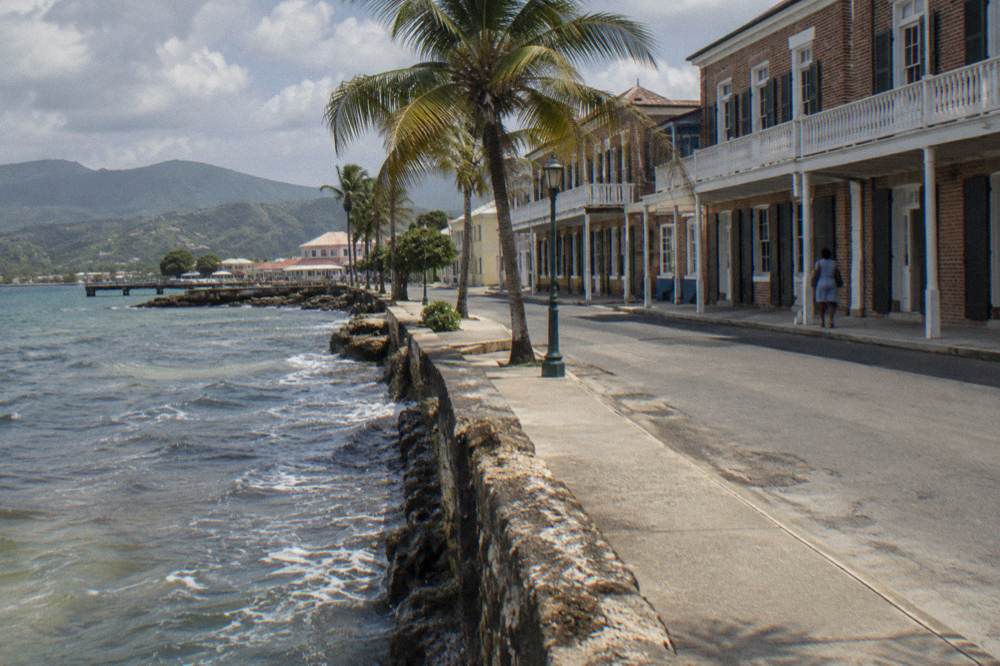 Brick buildings along a quiet seaside street in daylight