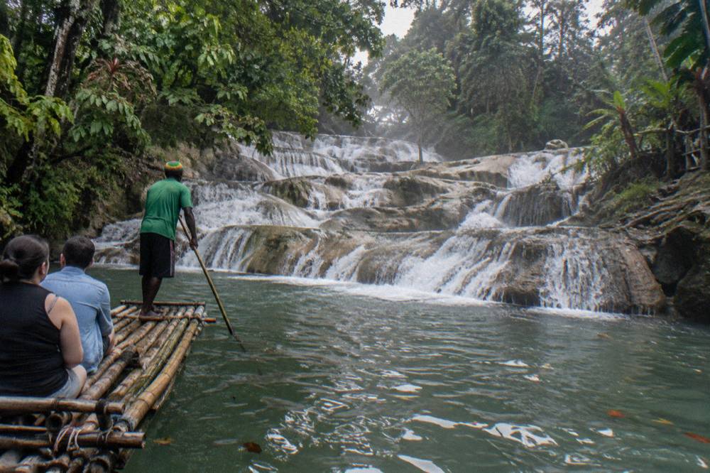 Terraced limestone steps of a waterfall with water pouring between pools